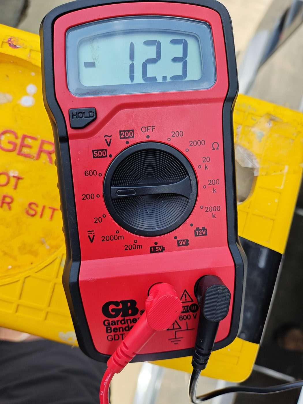 Multimeter used while testing voltage on the marker-light camera power circuit
